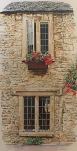 the image depicts a stone house adorned with vibrant flowers in the window.