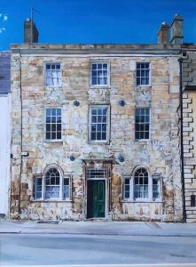 A three story Cotswold Stone building with a green front door.